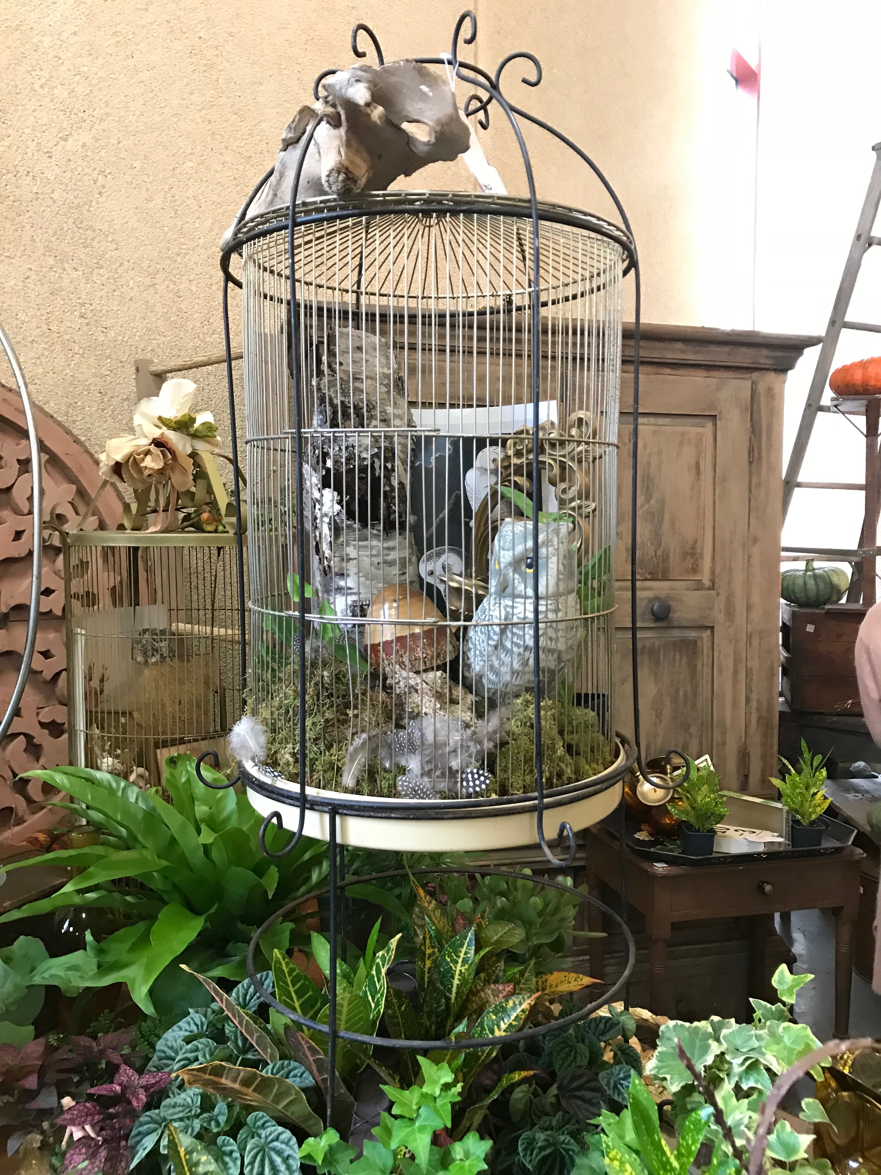Birdcage filled with whimsical items